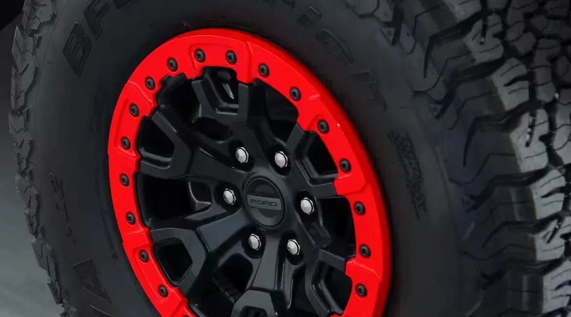 Off-road tire with red and black rim