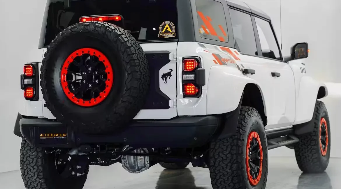 White off-road SUV with red-accented wheels