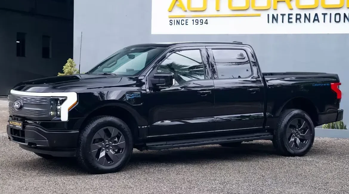 Black pickup truck parked outside dealership building