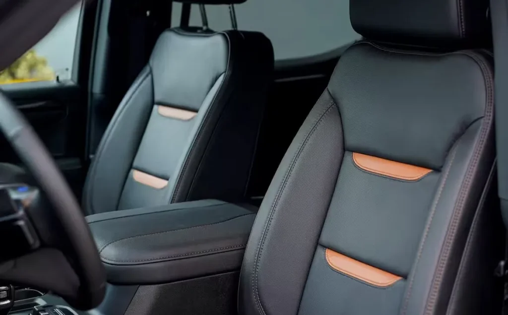 Modern black leather car seats with orange accents