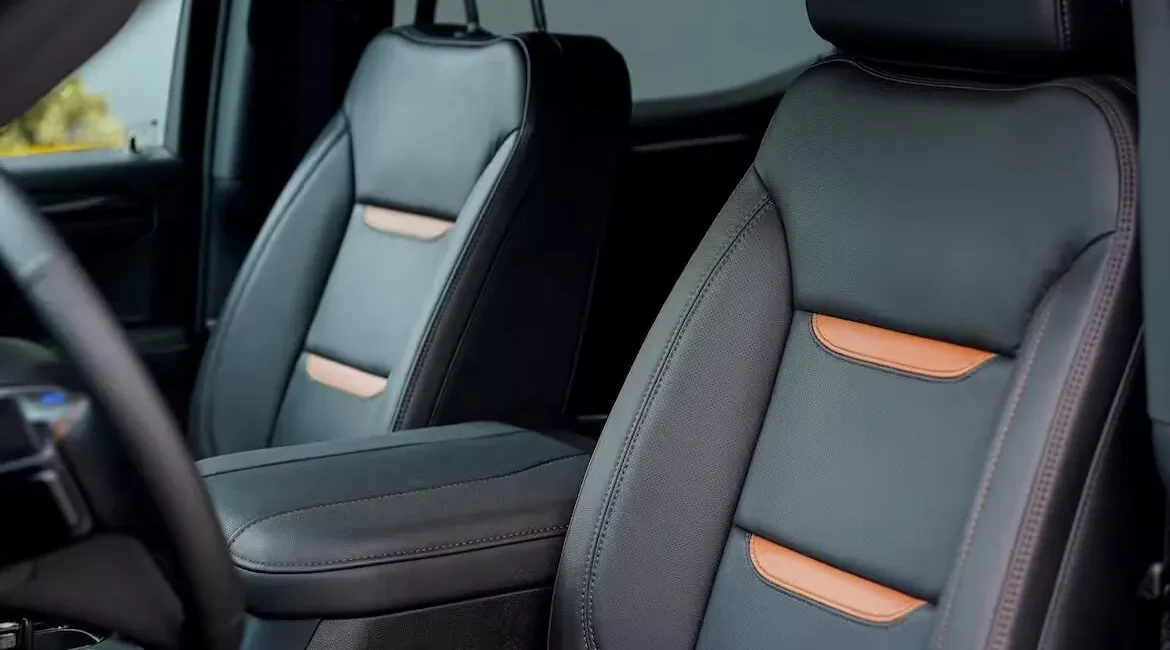Modern black leather car seats with orange accents