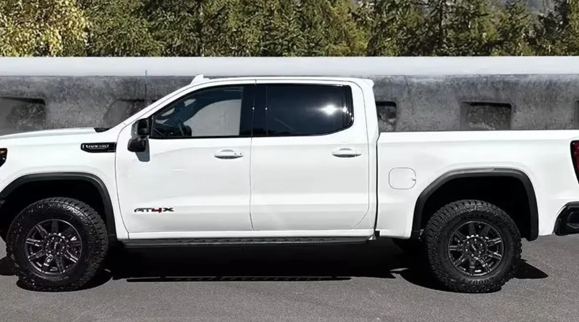 White pickup truck parked on mountain road