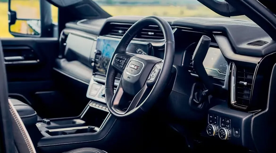 Modern GMC truck interior with steering wheel and dashboard