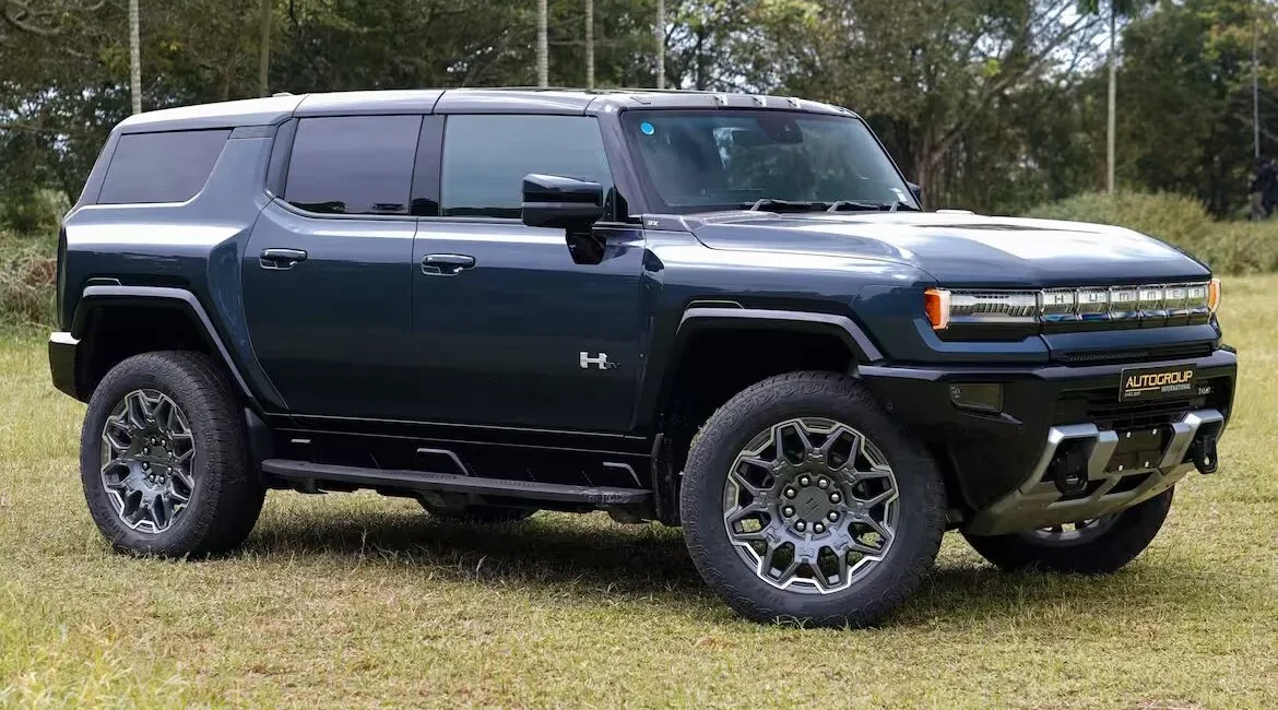 Electric Hummer SUV parked on grassy field