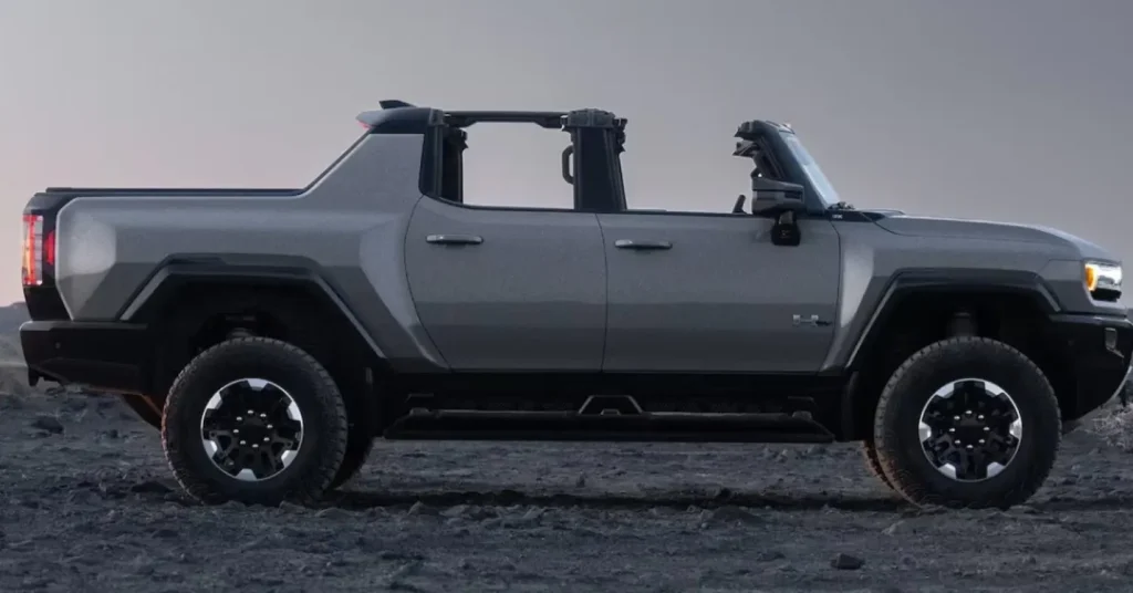 Silver electric pickup truck on rocky terrain