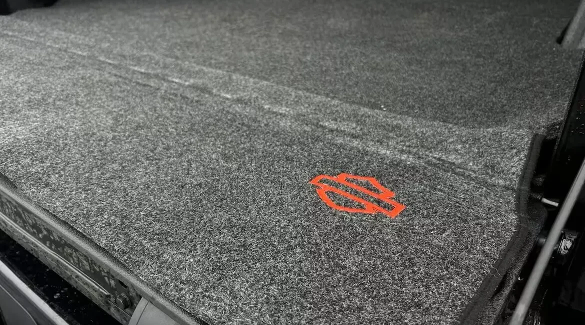Car trunk carpet with orange logo