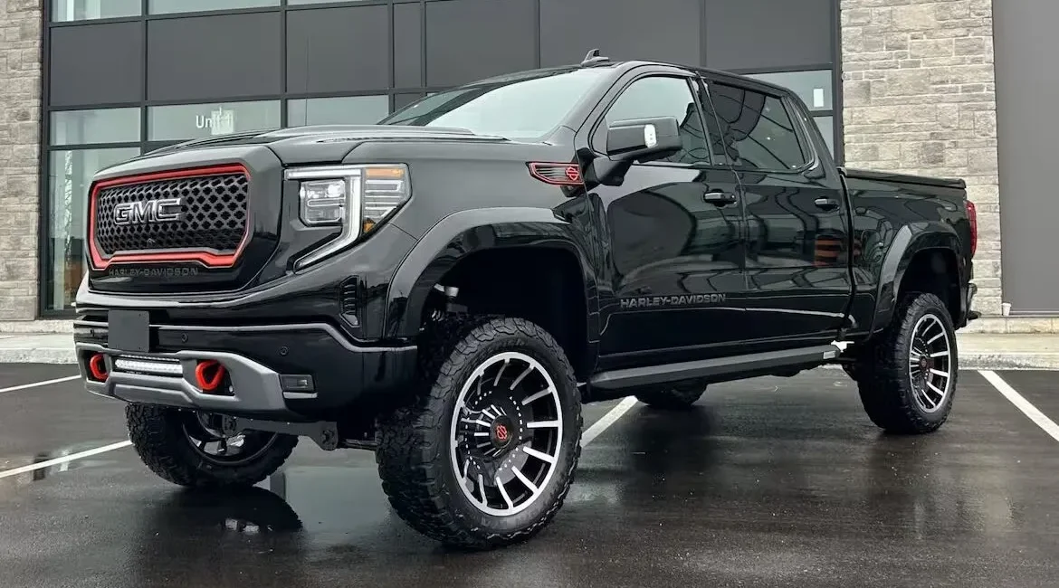 Black lifted GMC Harley-Davidson truck parked outside building