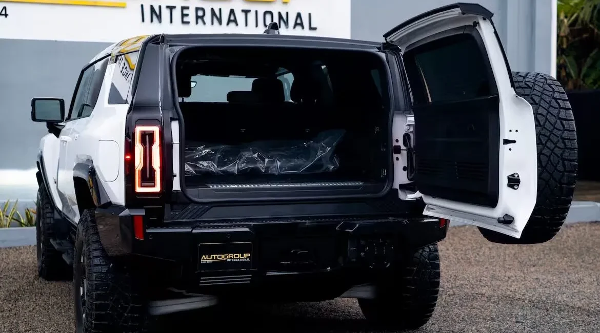 White SUV with open rear cargo door