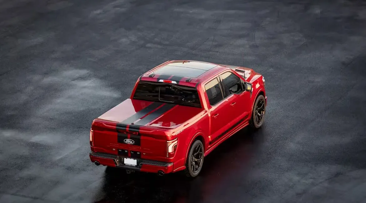 Red Ford pickup truck with black racing stripes