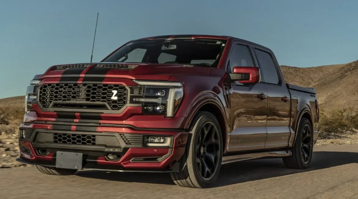 Red pickup truck driving through a desert road
