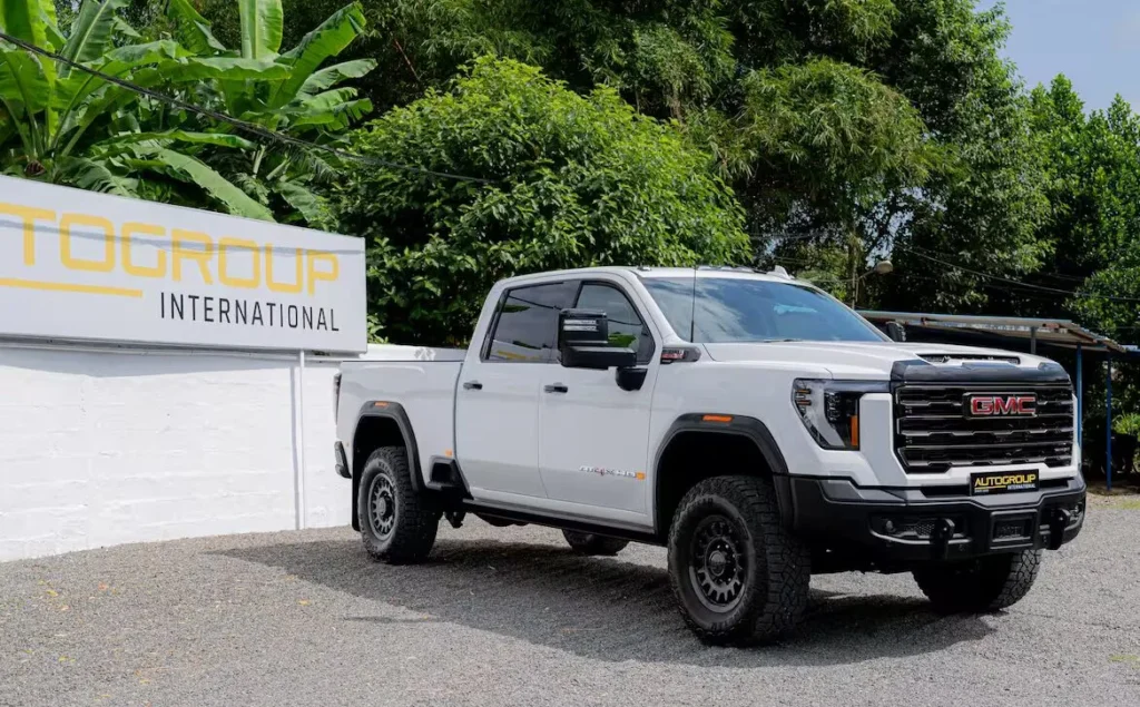 White GMC pickup truck parked outside dealership