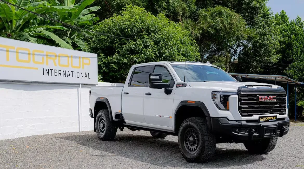 White GMC pickup truck parked outside dealership