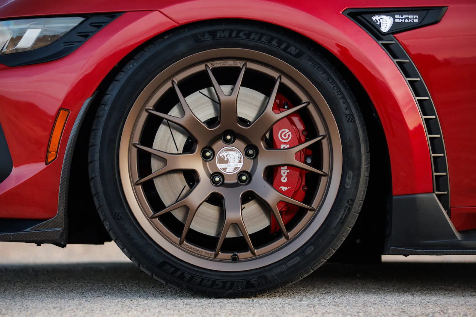 Bronze alloy wheel on red sports car