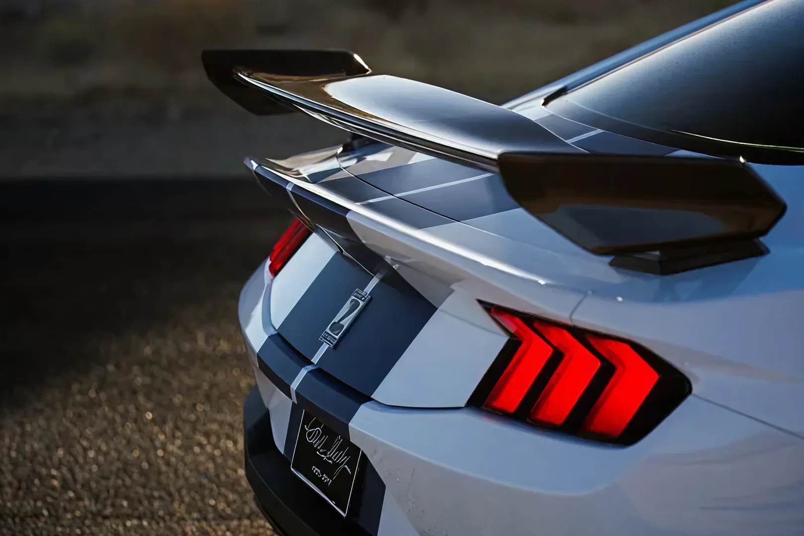 White sports car rear with spoiler and taillights