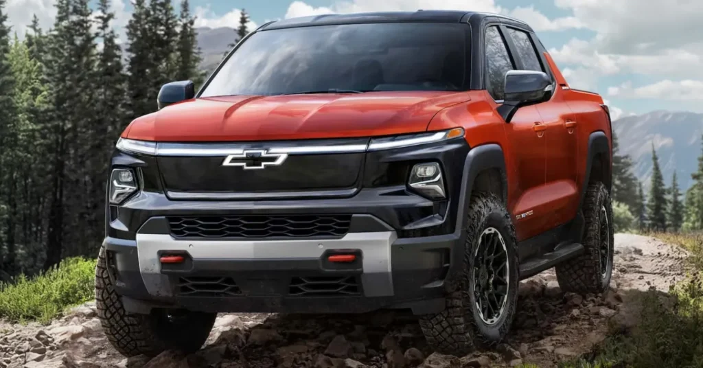 Red Chevrolet pickup truck driving off-road