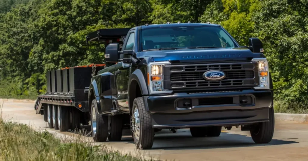 Black Ford truck towing large trailer