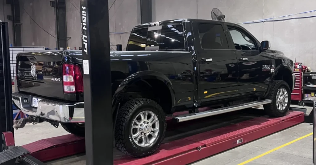 Black Ram 4x4 pickup on service lift