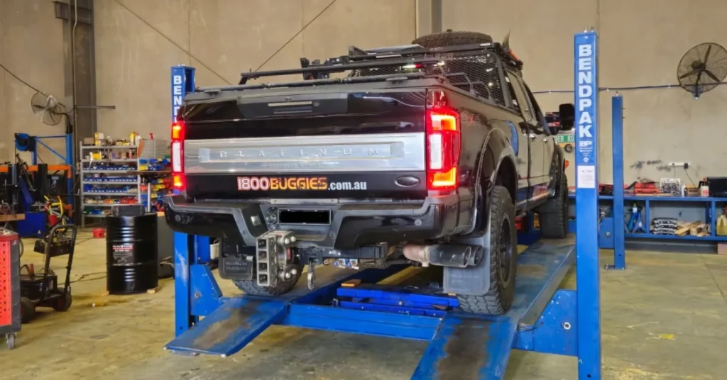 Pickup truck on hydraulic lift in auto shop
