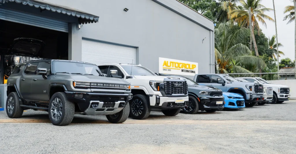 Lineup of pickup trucks outside auto dealership