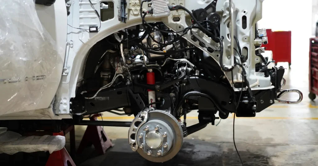 Truck chassis with exposed brake assembly in workshop
