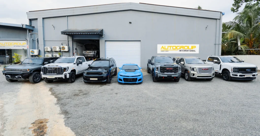 Lineup of trucks and sports car outside dealership